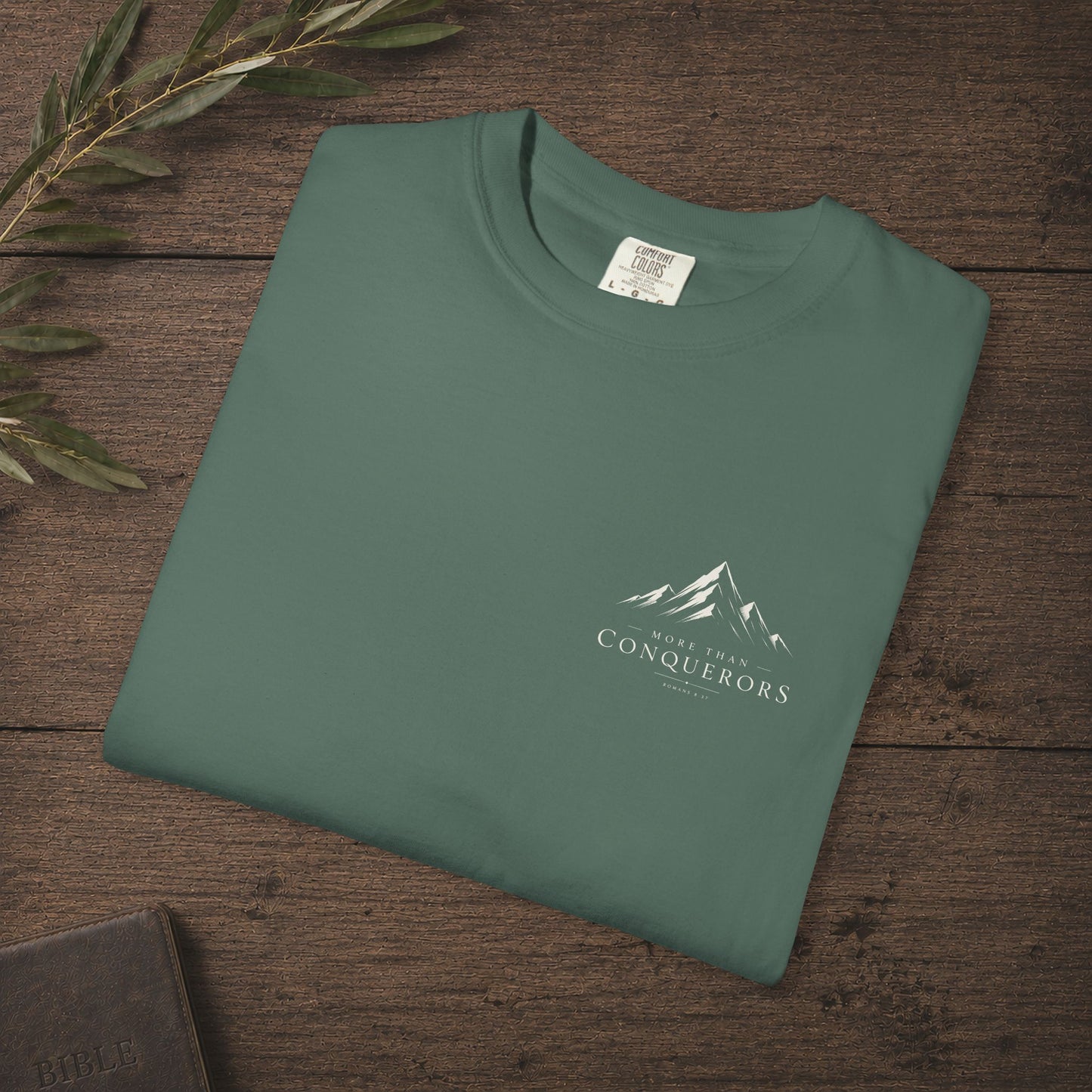 More than Conquerors — Romans 8:37 Subtle Scripture Tee | Chest Print