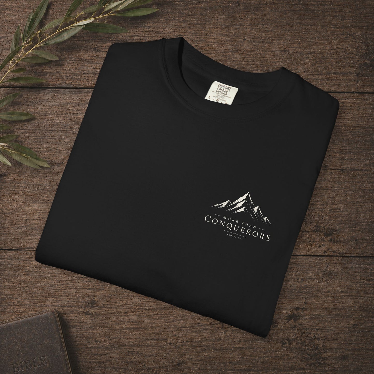 More than Conquerors — Romans 8:37 Subtle Scripture Tee | Chest Print