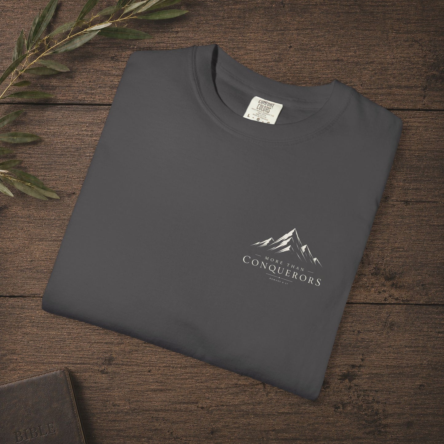 More than Conquerors — Romans 8:37 Subtle Scripture Tee | Chest Print